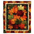 Autumn maple leaves quilted border throw blanket held open by woman