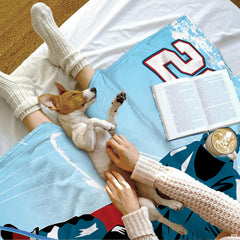 Full display of two ice hockey players in competition on decorative light blue rink throw