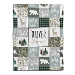 Woodland patchwork visual motif with evergreen pines, deer, bears, and rustic plaid squares in sage and taupe.