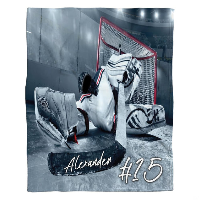 Ice hockey goalie blanket showing goaltender making butterfly save in front of red net.
