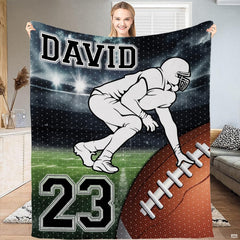 Football lineman stance stadium throw blanket displaying player on green turf under arena lights