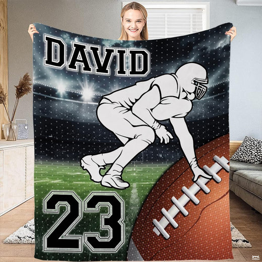 Football lineman stance stadium throw blanket displaying player on green turf under arena lights