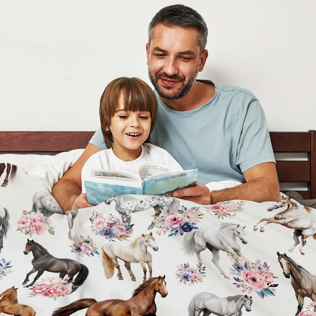 Woman holding open watercolor horses and floral throw blanket in bright sunny room