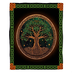 Woman holding open Celtic Tree of Life throw blanket showing green knot border and orange corners