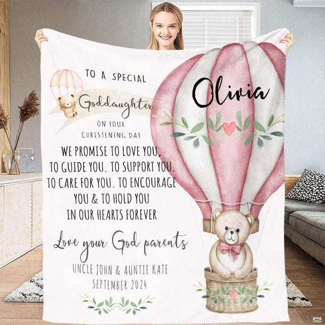 Teddy bear riding in a pink hot air balloon with olive leaves nursery throw blanket