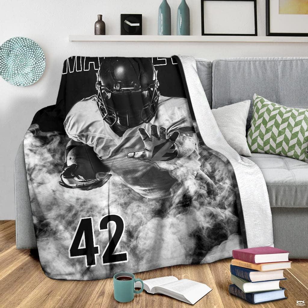 Grayscale football player graphic blanket displayed on armchair