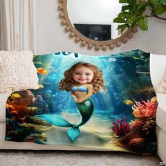 Oceanic mermaid graphic throw blanket folded across white living room couch beneath round mirror.