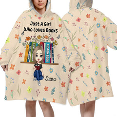 Close-up detail of floral bookshelf and reading girl illustration on throw blanket