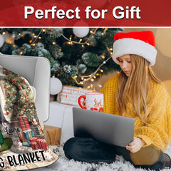 Holiday lifestyle scene displaying Christmas movie throw blanket beside a decorated tree.