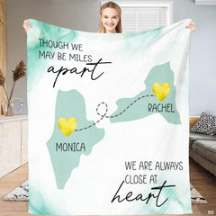 Folded throw blanket display showing mint state silhouettes and golden textured location markers.