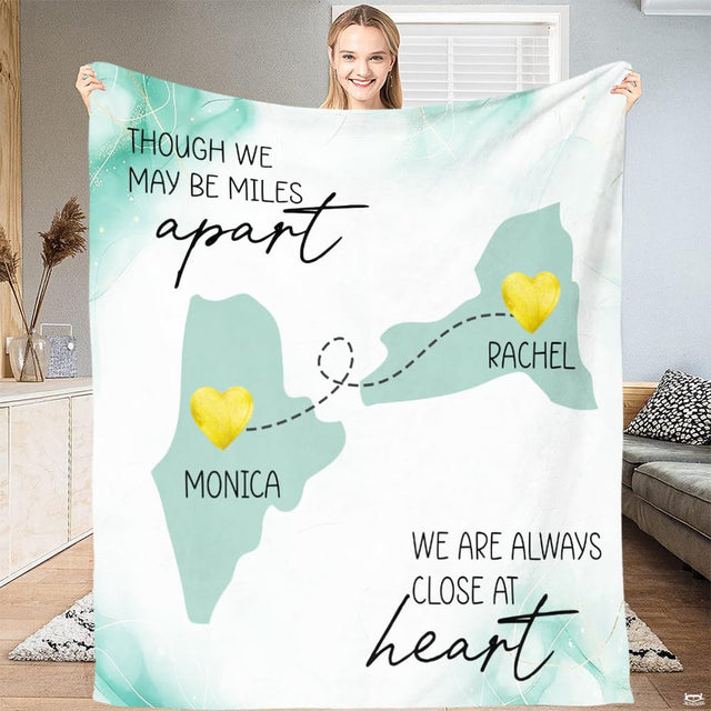 Folded throw blanket display showing mint state silhouettes and golden textured location markers.