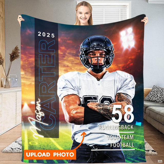 Woman holding up football player graphic throw blanket showing athlete on field under stadium floodlights.