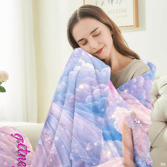 Fairytale portrait blanket shown spread out displaying full cloud and rainbow illustration.