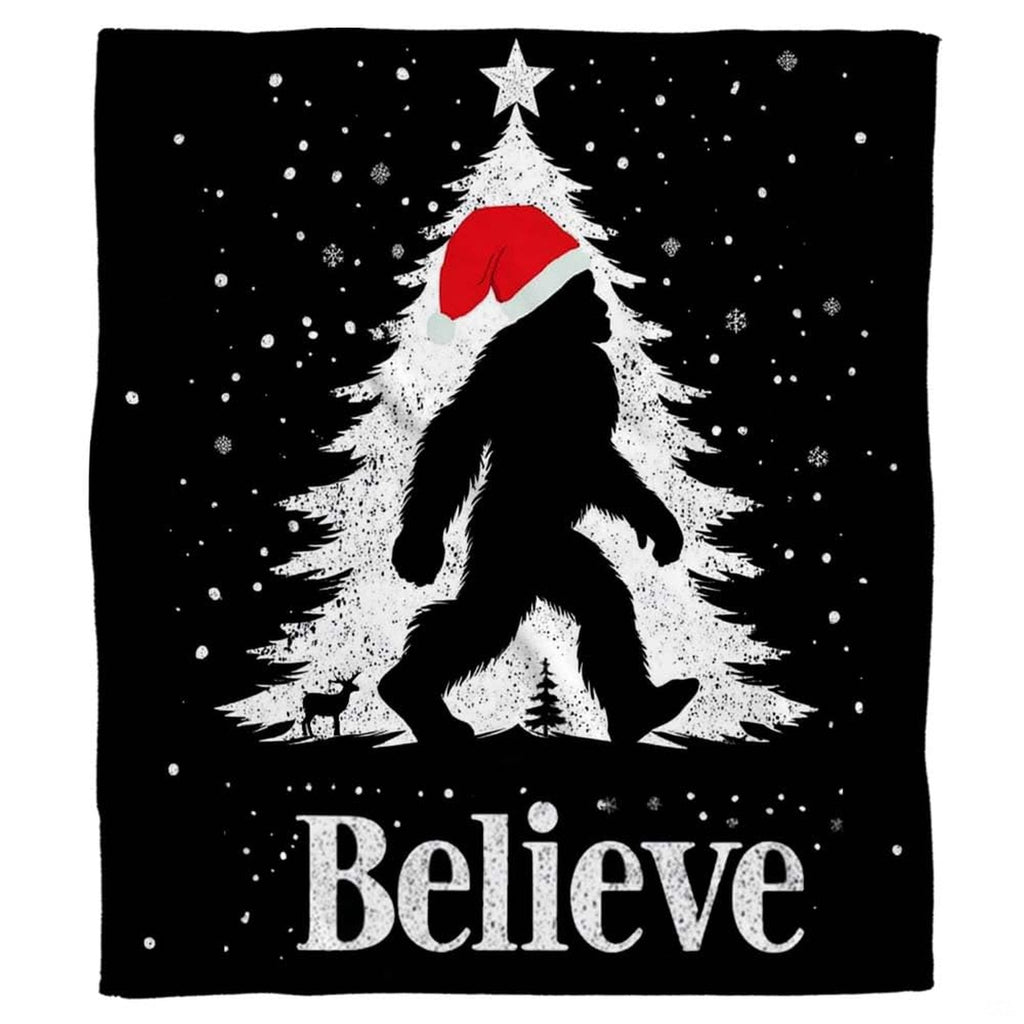 Christmas Bigfoot throw blanket view 2 highlighting Santa hat silhouette, falling snow, and festive tree