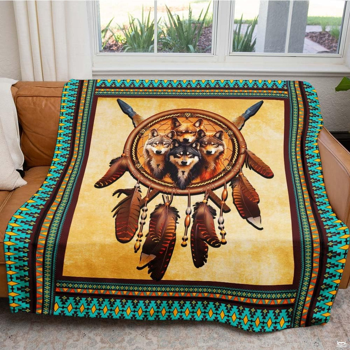 Bedding display highlighting intricate teal and orange southwestern geometric patterns and feathers.