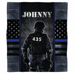 Tactical police officer armor graphic blanket draped across sofa
