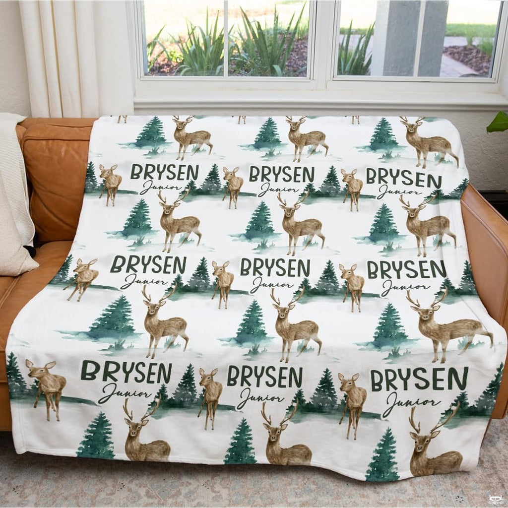 Artistic detail of thematic accent fawn and horned stag graphics on crisp white bedding.