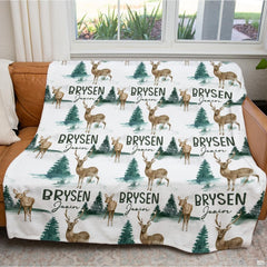 Artistic detail of thematic accent fawn and horned stag graphics on crisp white bedding.