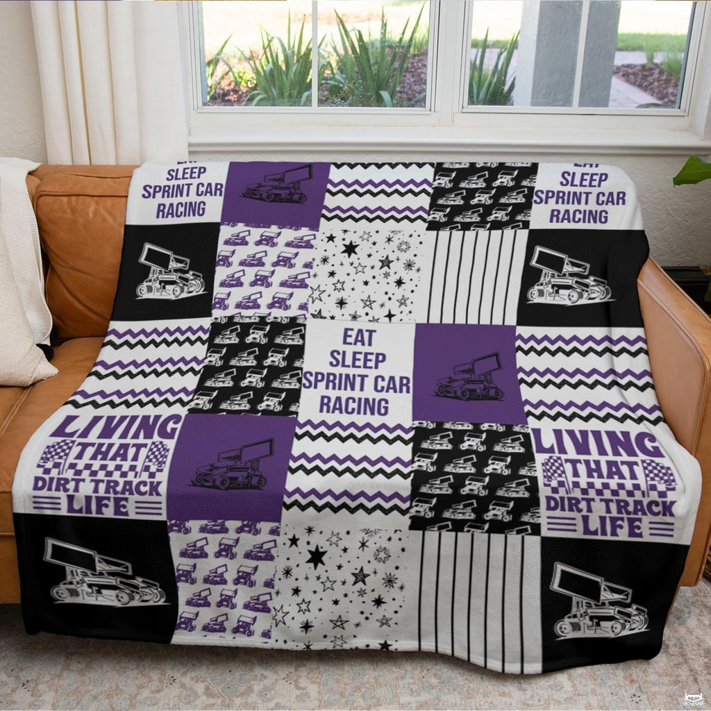 Checkered thematic accent flags and speedway artwork on a violet collage bedding set.