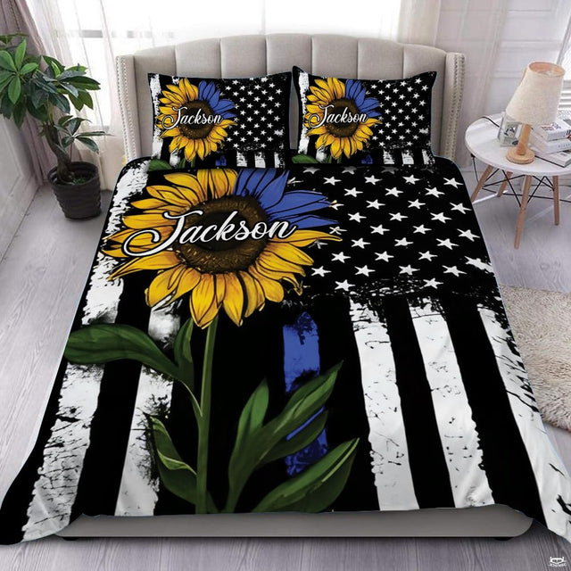 Bedroom display with yellow and blue sunflower over a distressed monochrome flag and narrow blue stripe