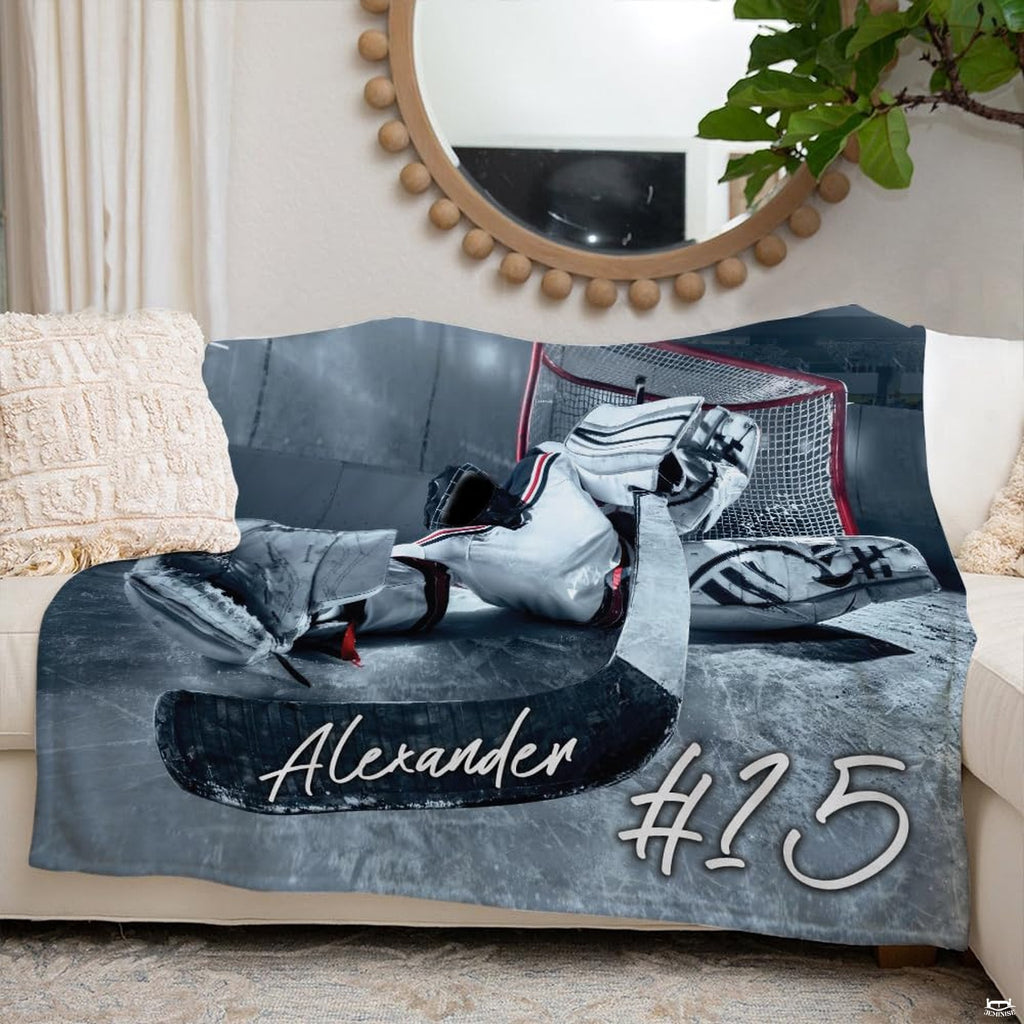 Ice hockey goalie sports blanket styled neatly across an ivory living room couch.