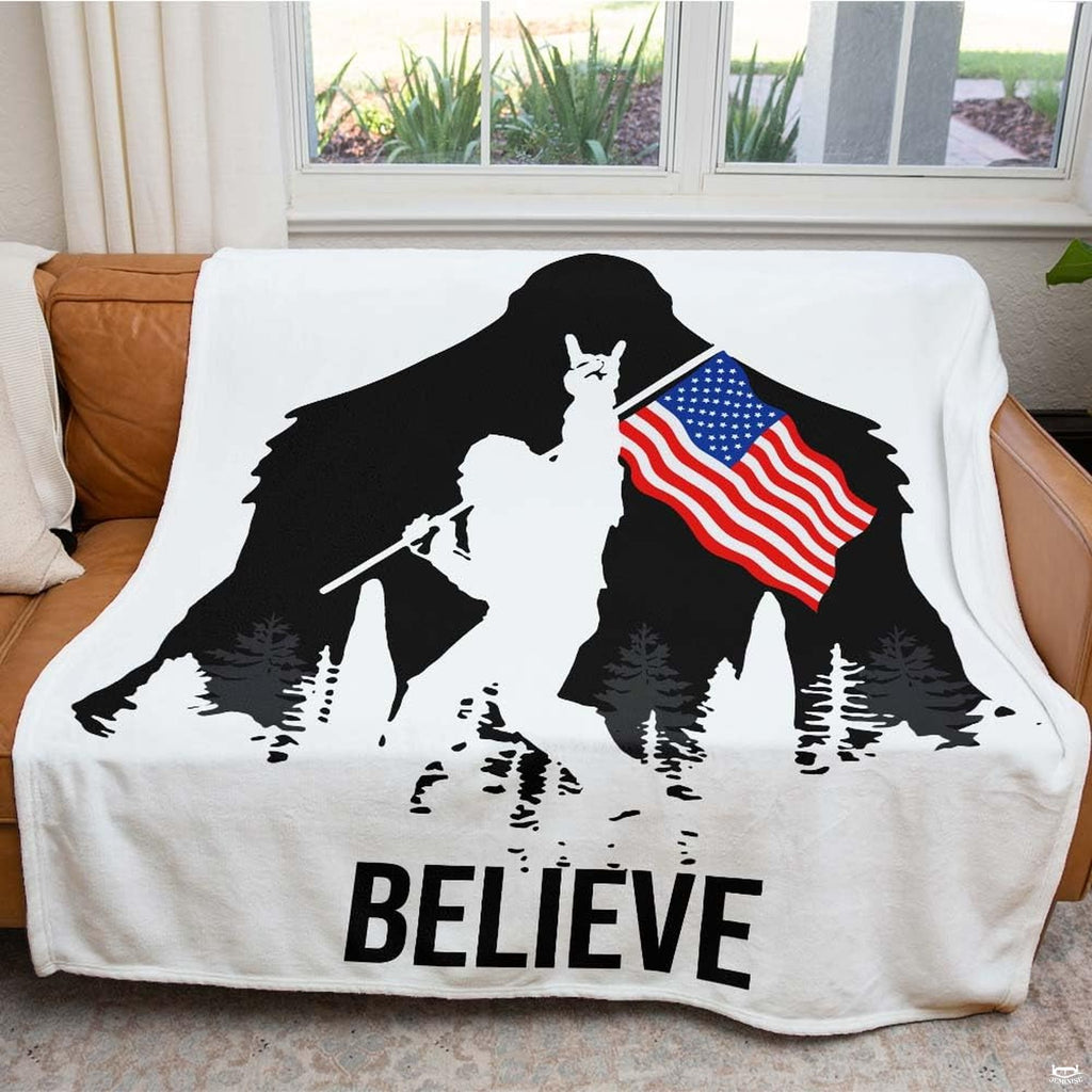 Bigfoot silhouette with rock hand sign, American flag, pine trees, and bold typography, view 3.