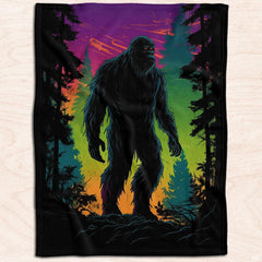 Top-down flat view of the colorful neon Bigfoot and pine tree artwork displayed on a wooden surface.