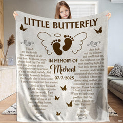 Full view of winged infant footprints memorial butterfly blanket held up indoors.