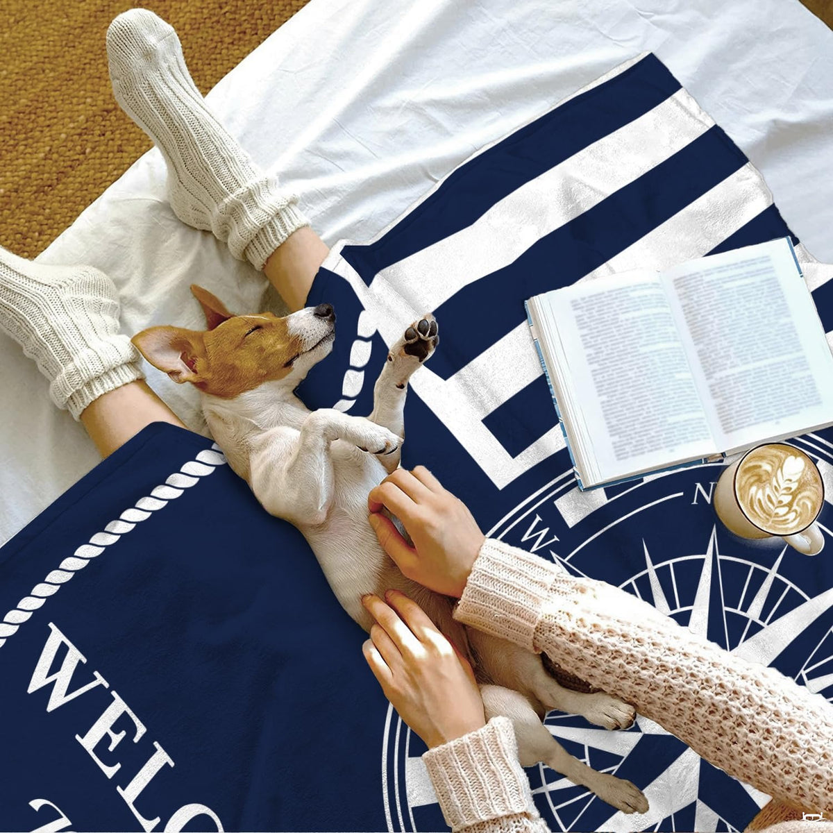 Close up of nautical compass throw blanket displaying braided rope border and navigation dial