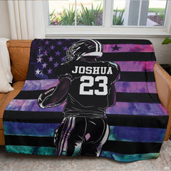 Living room sofa display showcasing the football athlete and starry galaxy flag artwork.