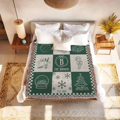 Detailed view of snow globe and winter cottage artwork on forest green holiday bedding.