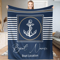 Nautical anchor bedding set centered on bed with navy and white sailor stripes and rope border.
