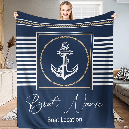 Nautical anchor bedding set centered on bed with navy and white sailor stripes and rope border.