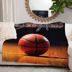 Folded corner of basketball court sports throw blanket highlighting rich amber tones