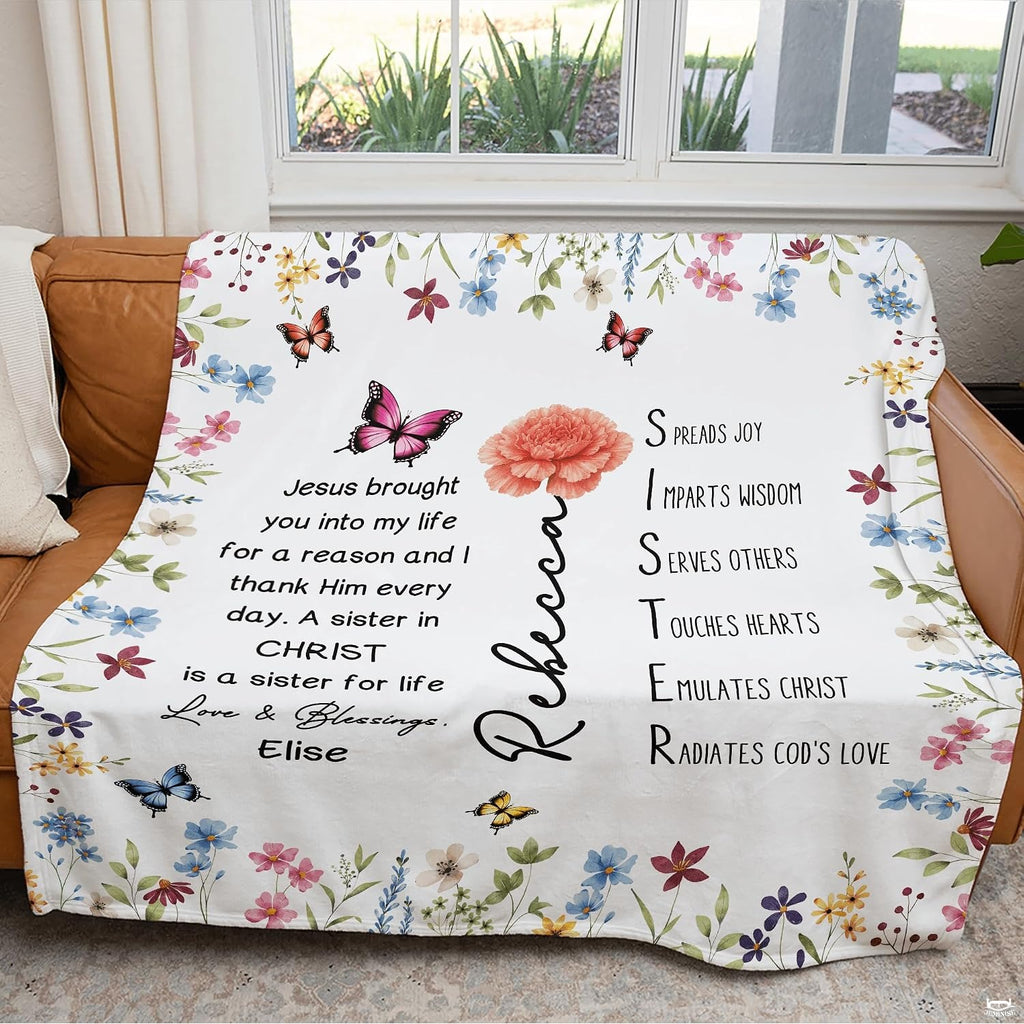 Floral butterfly blanket draped over couch near window.