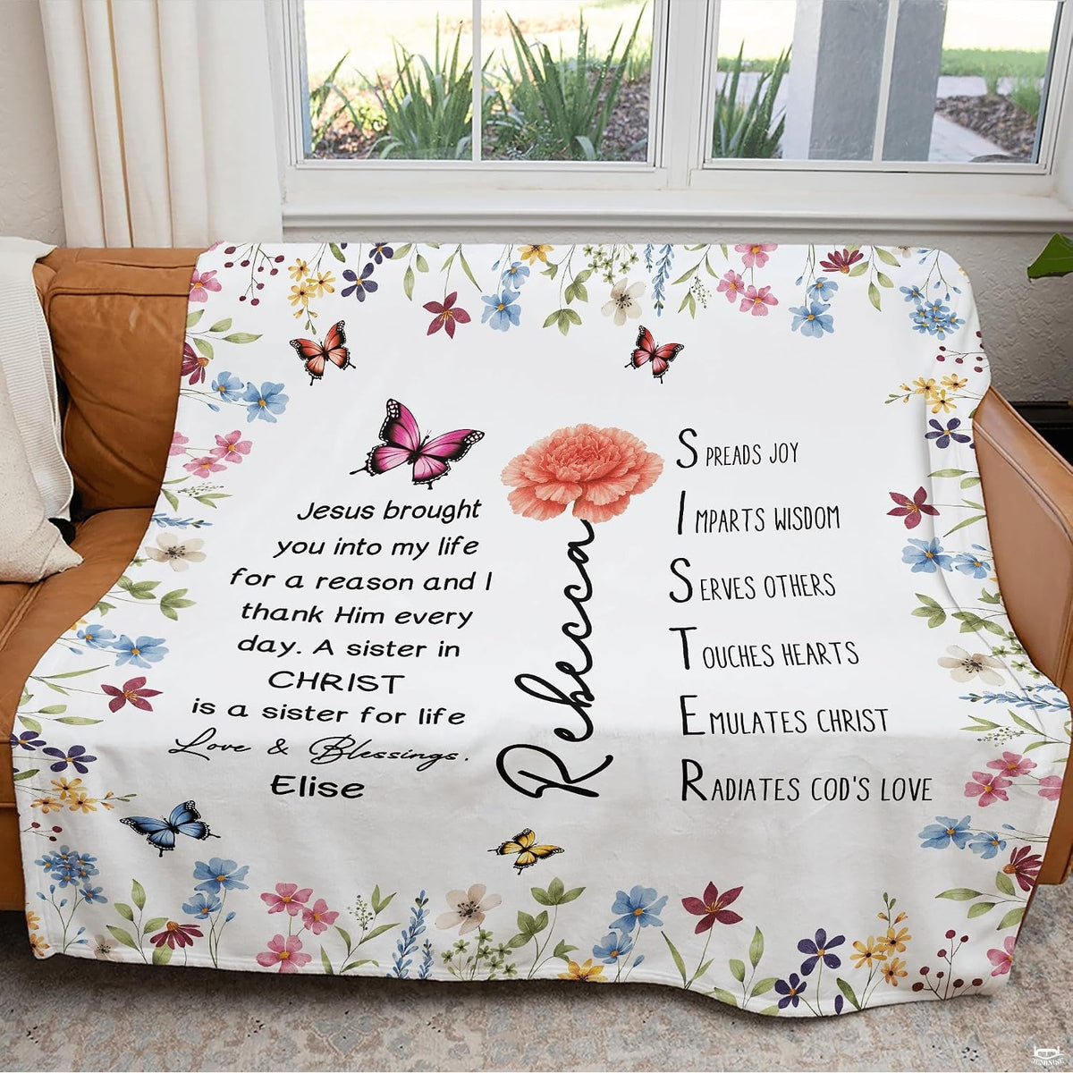 Floral butterfly blanket draped over couch near window.