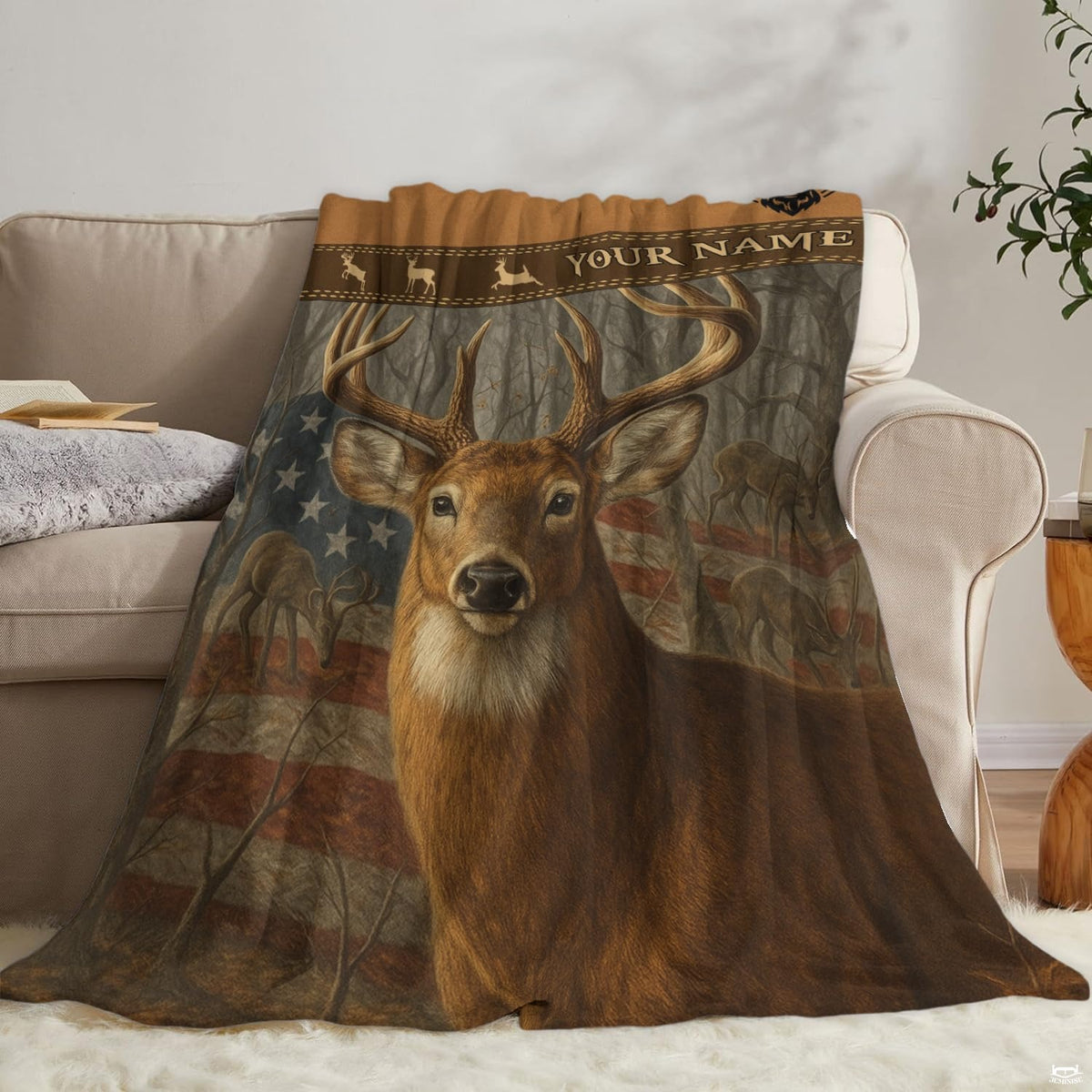 Patriotic buck wildlife blanket draped neatly over a living room couch beside an accent pillow.