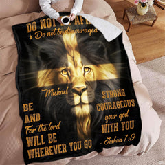 Overhead view of person holding a beverage mug beside a draped lion face throw blanket.