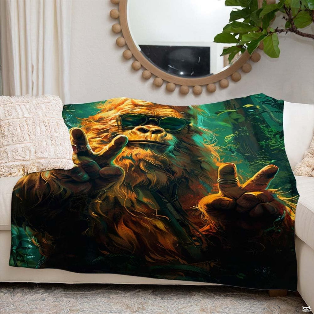 Angle view of groovy Bigfoot throw blanket showing crisp edges and emerald canopy backdrop