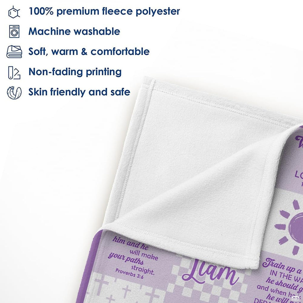 Folded lavender Bible verse throw blanket styled on a wooden crib railing