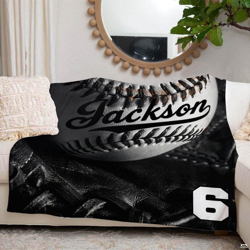 Monochrome studio still-life of a baseball inside a black fielder glove with dramatic lighting, view 6.
