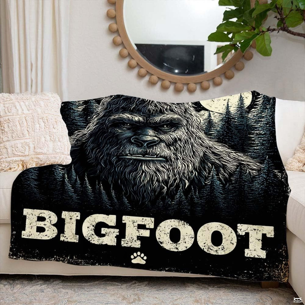 Sasquatch night forest throw blanket draped casually across a contemporary living room armchair