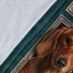Close-up detail shot of the Dachshund blanket showing edge detail and teal snowflake art.