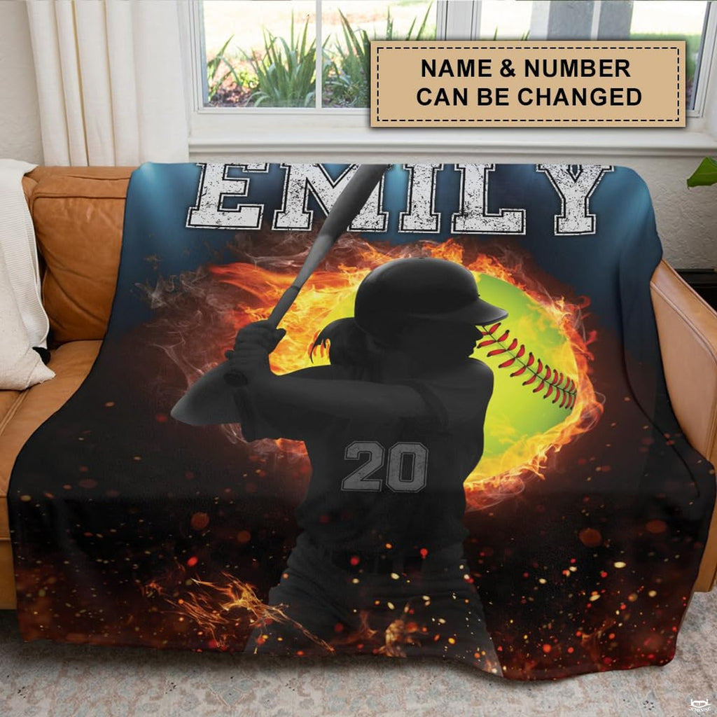 Athletic graphic featuring a fiery yellow softball and glowing sparks in stadium lighting.
