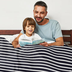 Nautica bedding sets visual motif with red ship anchor artwork displayed in bedroom decor.