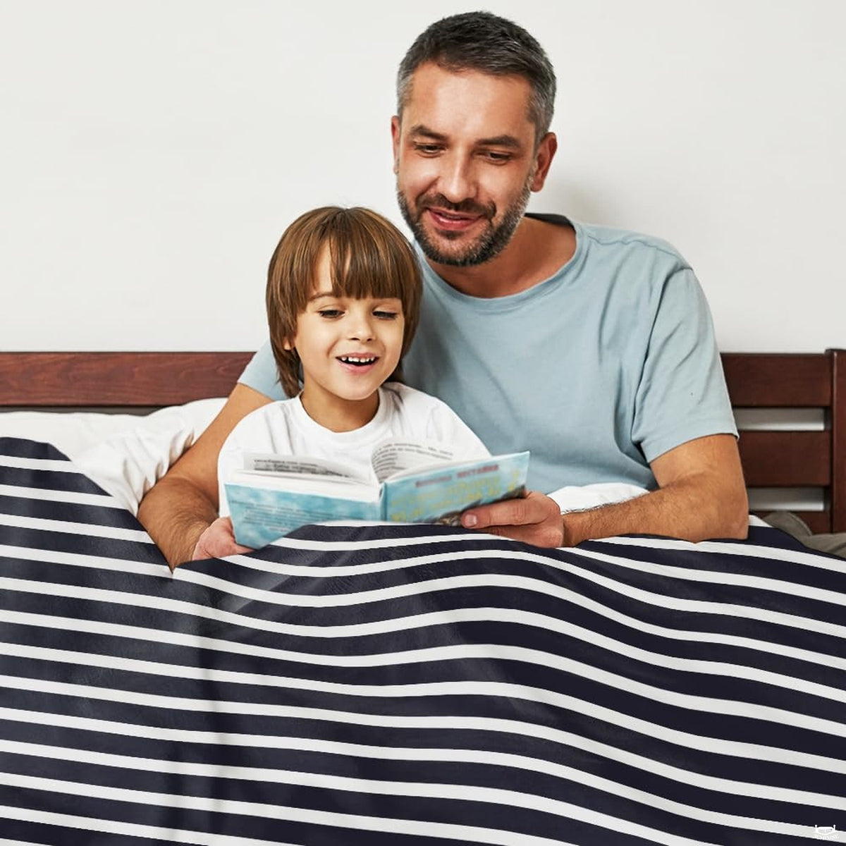 Nautica bedding sets visual motif with red ship anchor artwork displayed in bedroom decor.