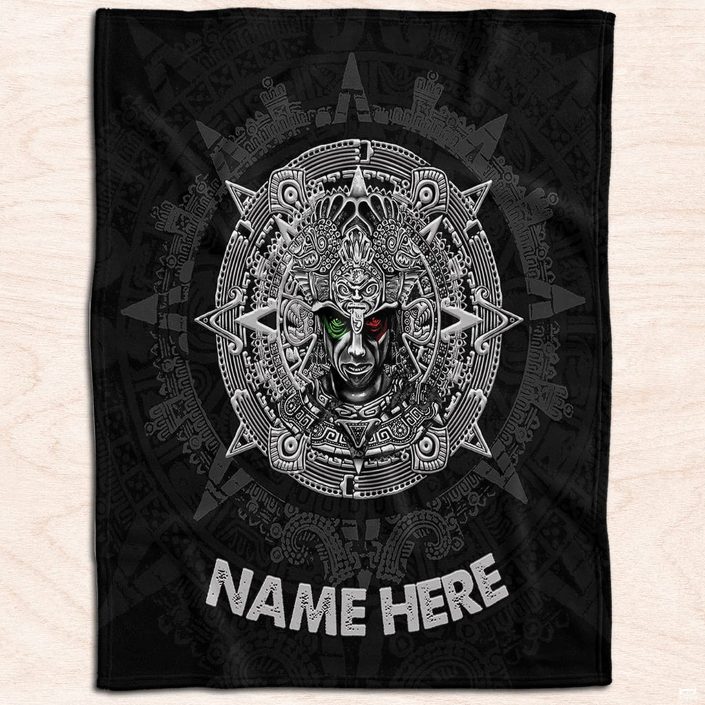 Ancient Mexican warrior medallion textile displayed flat on light natural wood planks.