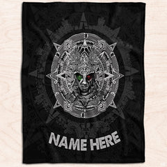 Ancient Mexican warrior medallion textile displayed flat on light natural wood planks.
