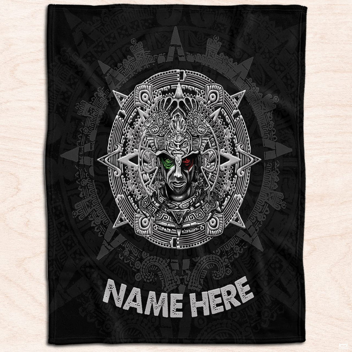 Ancient Mexican warrior medallion textile displayed flat on light natural wood planks.
