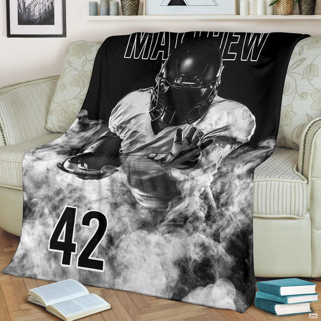 Monochrome gridiron defender smoke blanket draped over sofa